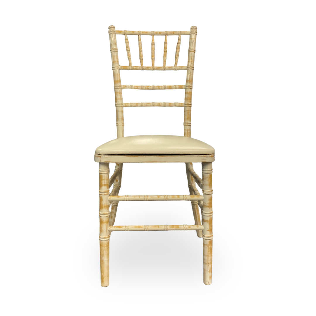 Beige wooden chair with a cushioned seat on a white background
